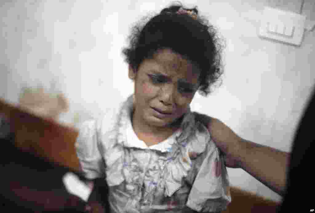 A Palestinian girl cries while receiving treatment for her injuries caused by an Israeli strike at a U.N. school in Jebaliya refugee camp, at the Kamal Adwan hospital in Beit Lahiya, northern Gaza Strip, July 30, 2014. 