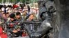 Philippine troops prepare to lay white roses at the Marawi Memorial for fellow soldiers killed in the five-month siege of Marawi city in southern Philippines by the Islamic State fighters.