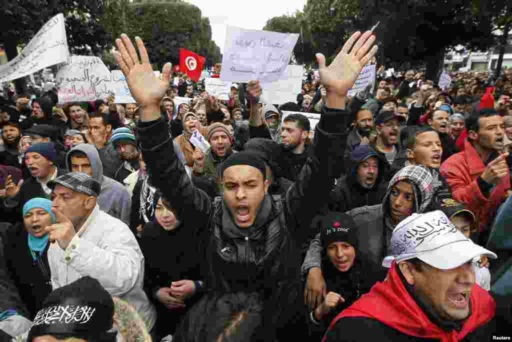 Supporters of the ruling Ennahda party shout slogans in support of the party during a demonstration in Tunis, Feb. 9, 2013.