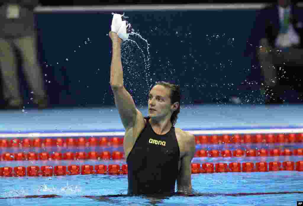 Hungary's Katinka Hosszu celebrates after setting a new world record and winning the gold medal in the women's 400-meter individual medley final during the swimming competitions at the 2016 Summer Olympics, Aug. 6, 2016.