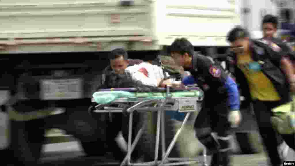 Rescuers and medical officers push an injured person on a gurney at the site of a bomb blast in Hua Hin, south of Bangkok.