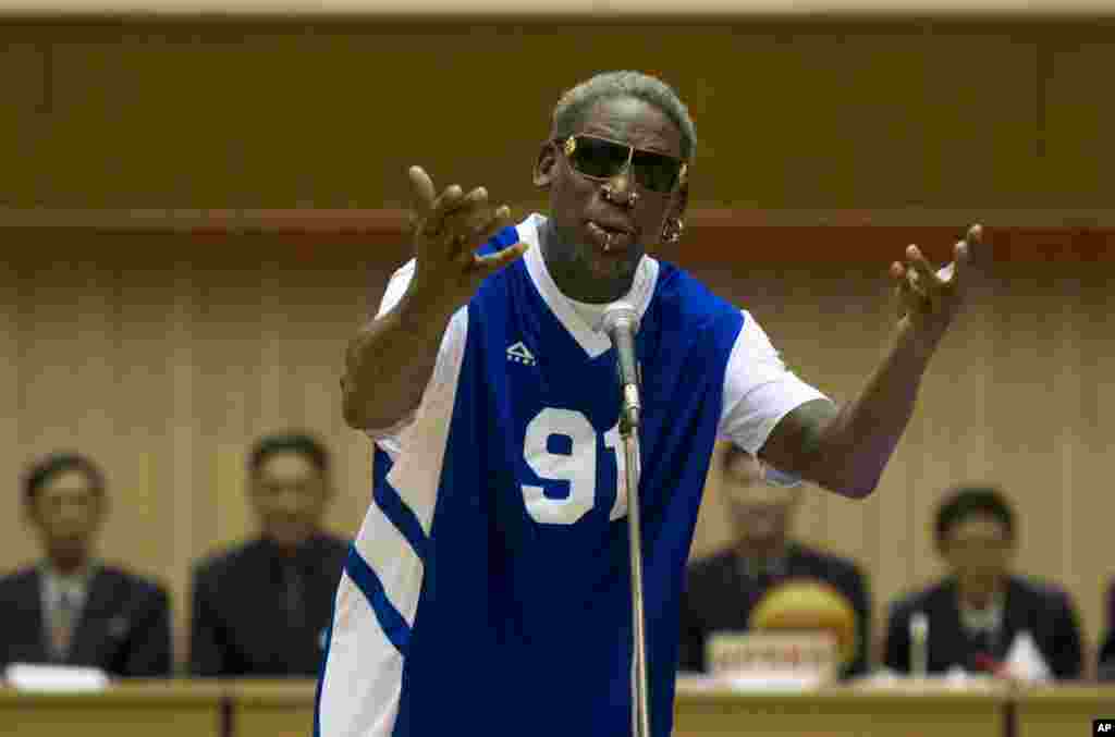 Dennis Rodman sings Happy Birthday to North Korean leader Kim Jong Un, seated above in the stands, before an exhibition basketball game in Pyongyang, Jan. 8, 2014.