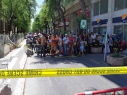 People are prevented to enter a security area after an explosion in Tunis, Thursday June 27, 2019.