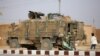 A Turkish soldier stands near his armored vehicle on a highway near the northern Syrian town of Ain Issa in the Raqqa region, on Nov. 26, 2019, as Turkey-backed forces deploy reinforcements around the town.