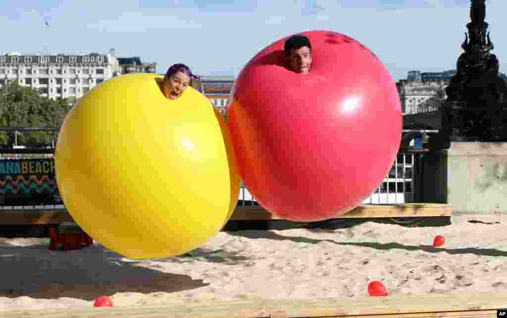 The married American couple Christina Gelsone and Seth Bloom participate in the clown-duo Acrobuffos as part of the Southbank Centre’s Festival of Love, in London.