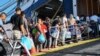 Refugees and migrants board a ferry on the island of Lesbos to be transferred to the port of Piraeus, Oct. 6, 2019. 