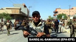 IRAQ -- Members of Iraqi Shiite group known as Hashd al-Shaabi (The Popular Crowd) patrol an area in Tuz, southern Kirkuk city, Iraq, 17 October 2017 (issued 18 October 2017)
