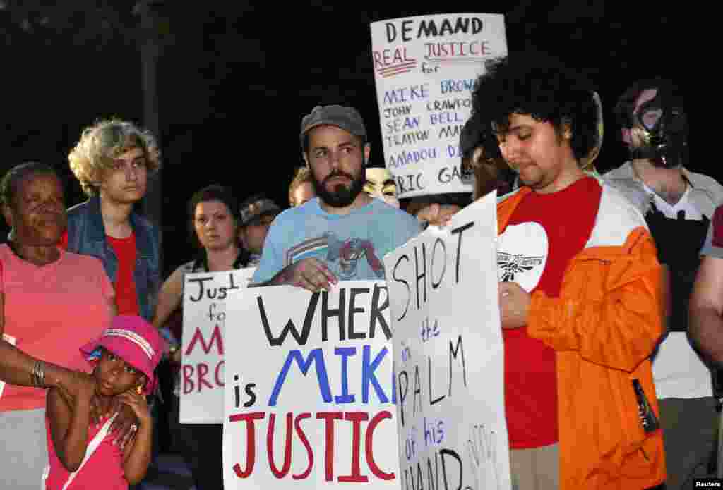 People gather outside the White House as part of a "National Day of Rage" protest against the fatal shooting of Michael Brown in Ferguson, Missouri, Aug. 21, 2014.