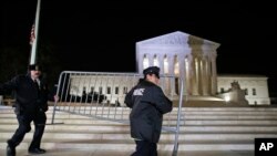Supreme Court police officers move a barricade in front of the U.S. Supreme Court, Feb. 19, 2016 in Washington. 