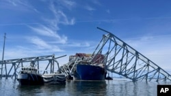 The fallen Francis Scott Key Bridge in Baltimore is pictured March 31, 2024, where divers assisted crews with the complicated and meticulous operation of removing steel and concrete.