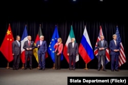 FILE - Secretary Kerry poses for a group photo with fellow EU, P5+1 foreign ministers and Iranian Foreign Minister Zarif after reaching Iran nuclear deal, in Vienna, Austria, July 14, 2015.