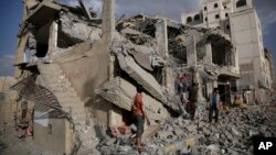 Yemeni men inspect a house destroyed by a Saudi-led airstrike in Sanaa, Yemen, Monday, Jan. 25, 2016.