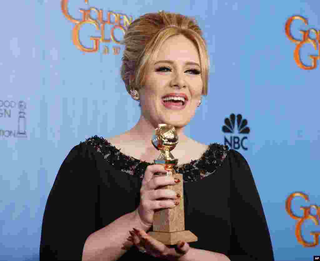 Adele, winner for Best Original Song - Motion Picture, for "Skyfall" from the film of the same name, poses with her award backstage at the 70th annual Golden Globe Awards in Beverly Hills, California, January 13, 2013.