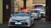 FILE - A police convoy escorts two buses with tinted windows leaving the high-security Lefortovo Prison in Moscow, Russia, Sept. 7, 2019.