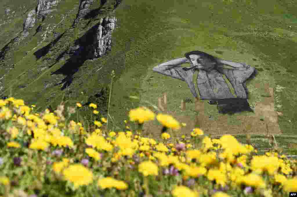 A painting, created by French artist Saype and said to be the world's largest biodegradable painting, is seen on the Chaux-de-Mont ski slope above the Alp resort of Leysin, Switzerland.