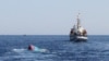 FILE - A Vietnamese sinking boat (L) which was rammed and then sunk by Chinese vessels near disputed Paracels Islands, is seen near a Marine Guard ship (R) at Ly Son island of Vietnam's central Quang Ngai province.