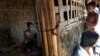 FILE - 17-year old Rorbiza rests at home of Dapaing, North of Sittwe, western Rakhine state, Myanmar after escaping from a human trafficking boat.