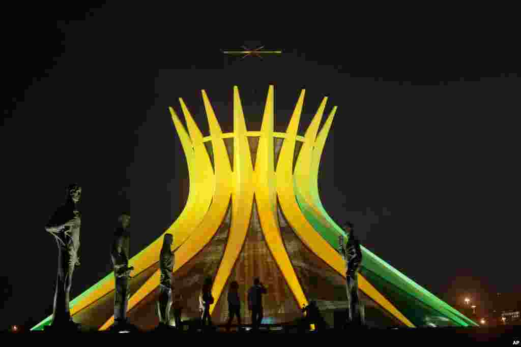 The Metropolitan Cathedral is illuminated in Brazil's national colors in honor of the upcoming World Cup, in Brasilia, Brazil, June 6, 2014.