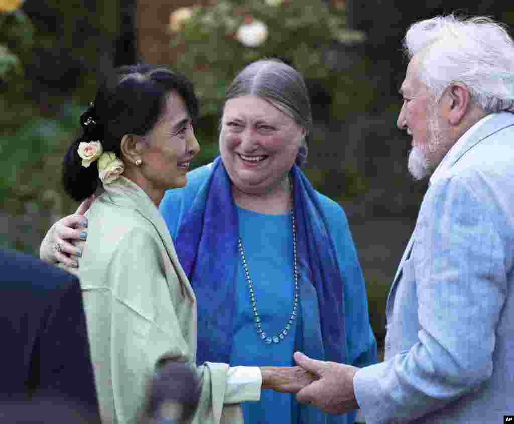 Aung San Suu Kyi, center, meets with people at a reception in Oxford, England, June 19, 2012.