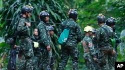 Thai rescuers prepare to enter the cave where 12 boys and their soccer coach have been trapped since June 23, in Mae Sai, Chiang Rai province, in northern Thailand, July 6, 2018.