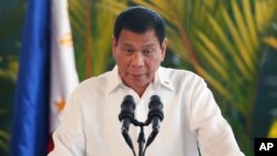 FILE - Philippine President Rodrigo Duterte speaks during a news conference at Ninoy Aquino International Airport in suburban Pasay City, south of Manila, Philippines, Oct. 25, 2016.