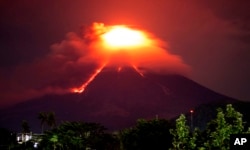 Lava cascades down the slopes of Mayon volcano as seen from Legazpi city, Albay province, around 340 kilometers (210 miles) southeast of Manila, Philippines, Monday, Jan. 15, 2018.