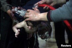 A child is treated in a hospital in Douma, eastern Ghouta, Syria, after what was alleged to have been a chemical weapons attack, April 7, 2018.