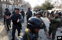 FILE - Security forces inspect the site of an Islamic State-claimed attack on a hospital in Kabul, Afghanistan, March 8, 2017.