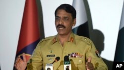 FILE - Pakistani military spokesman Major General Asif Ghafoor speaks to reporters in Rawalpindi, Pakistan, April 17, 2017. He said Oct. 14, 2017, that the rescue of a U.S.-Canadian family from Taliban activity offered a good opening in restoring mutual trust between Pakistan and the U.S.