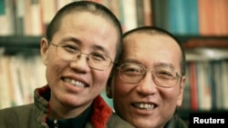 FILE - Chinese dissident Liu Xiaobo and his wife, Liu Xia, posed in this undated photo released by his family on Oct. 3, 2010. 