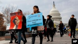 FILE - People march in support of the Deferred Action for Childhood Arrivals (DACA) and Temporary Protected Status (TPS) programs, Dec. 5, 2017, on Capitol Hill in Washington. 