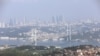 FILE - A general view of the July 15 Martyrs Bridge, or Bosphorus Bridge, as seen from a hill, in Istanbul, June 23, 2019. 