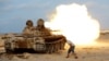 A fighter from Libyan forces allied with the U.N.-backed government fires a shell with a Soviet-made T-55 tank at Islamic State fighters in Sirte, Libya, Aug. 2, 2016. 