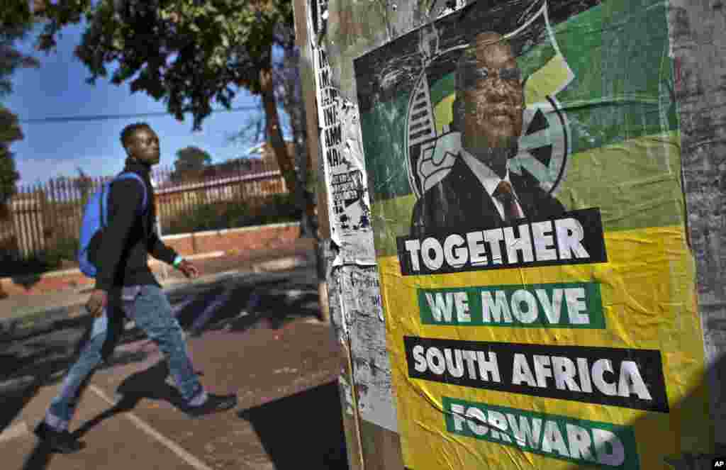 A man walks past an election poster of Jacob Zuma's African National Congress (ANC) party in the Soweto township of Johannesburg, South Africa, May 9, 2014.