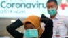 Seorang perempuan mengenakan masker pelindung di Stasiun Sudirman, Jakarta, 4 Februari 2020. (Foto: Ajeng Dinar Ulfiana/Reuters)