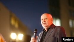 FILE - Former Soviet President Mikhail Gorbachev visits the former Berlin Wall border crossing point Checkpoint Charlie, in Berlin, Nov. 7, 2014. 