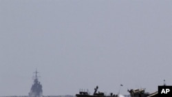 Israeli naval vessels (L) arrive at the port of Ashdod in southern Israel, 05 Jun 2010