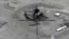 In this framegrabbed image provided by the U.S. Department of Defense shows airstrike footage on the Jeribe West Refinery in Syria Wednesday Sept. 24, 2014. 