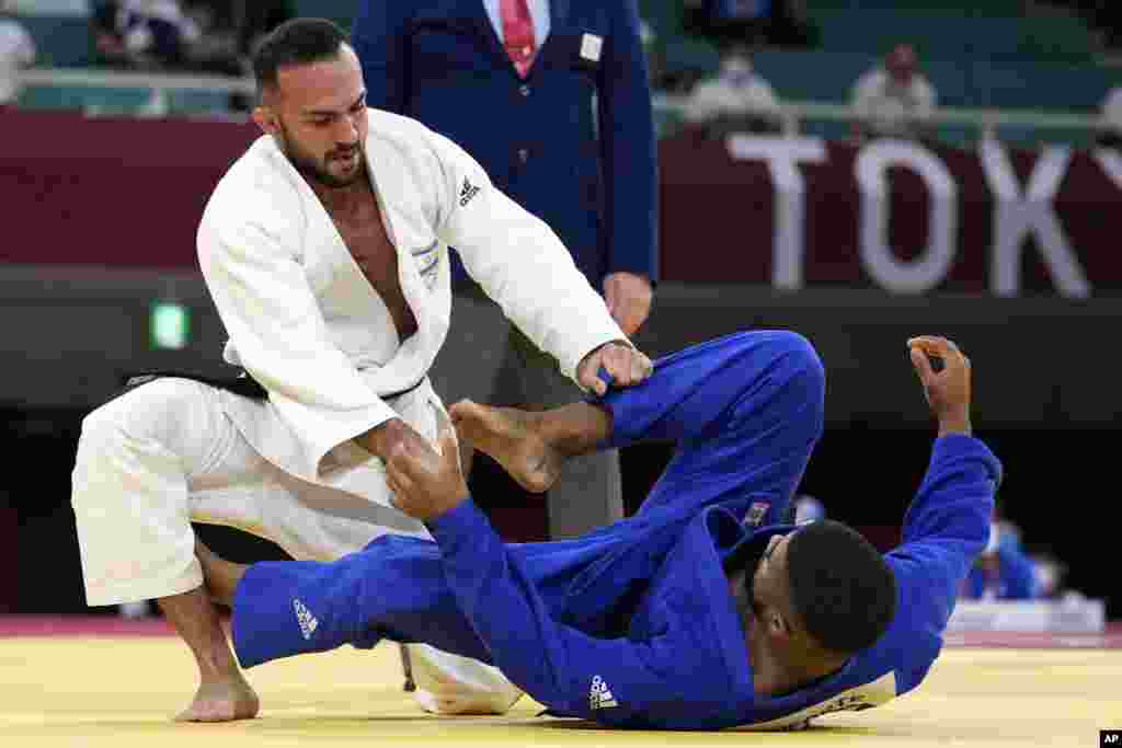 Baruch Shmailov of Israel, left, and Kevin Loforte of Mozambique compete during their men's -66kg round of 32 judo match at the 2020 Summer Olympics, Sunday, July 25, 2021, in Tokyo, Japan. (AP Photo/Vincent Thian)