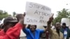 Zimbabweans rally against recent anti-immigrant violence in South Africa, outside the South African embassy in Harare, April 17, 2015.