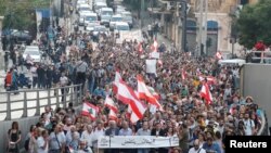 Demonstrators walk on the street during a protest in Beirut, Lebanon, Oct. 31, 2019. 
