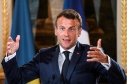 French President Emmanuel Macron delivers a speech during a press conference with Ukrainian President Volodymyr Zelenskiy at the Elysee Palace, in Paris, June 17, 2019.