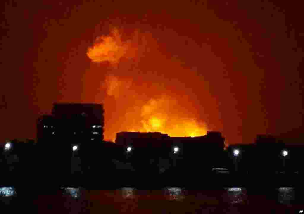 The night sky is lit up as a fire burns aboard the INS Sindhurakshak, an Indian Navy kilo class submarine, Mumbai, August 14, 2013.