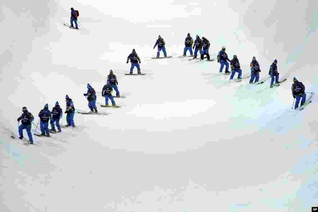 Volunteers check the condition of the half pipe at the Rosa Khutor Extreme Park, Krasnaya Polyana, Russia, Feb. 9, 2014.