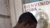 A poster showing Pope Benedict XVI, the Virgin of Charity of Cobre, Cuba's patron, is displayed on a window in Santiago de Cuba, Cuba, Sunday, March. 25, 2012. 
