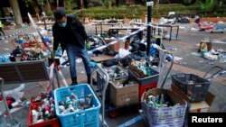 A police officer gathers forensic evidence at the campus of the Polytechnic University in Hong Kong, Nov. 28, 2019.