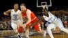 Syracuse's Trevor Cooney (10) drives against North Carolina's Nate Britt (0) and Theo Pinson (1) during the first half of the NCAA Final Four tournament college basketball semifinal game Saturday, April 2, 2016, in Houston. (AP Photo/David J. Phillip)