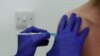 In this Wednesday, Oct. 7, 2020, file photo, a Phase 3 Novavax coronavirus vaccine trial volunteer is given an injection at St George's University hospital in London. (AP Photo/Alastair Grant, File)