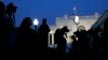 Dusk falls over the White House as members of the media wait for comment from Charlotte Charles and Tim Dunn, the parents of Harry Dunn, at the White House in Washington, Oct. 15, 2019.