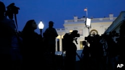 Dusk falls over the White House as members of the media wait for comment from Charlotte Charles and Tim Dunn, the parents of Harry Dunn, at the White House in Washington, Oct. 15, 2019.